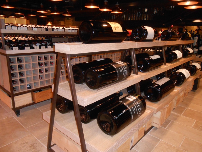 Different sizes of wine bottles on shelves